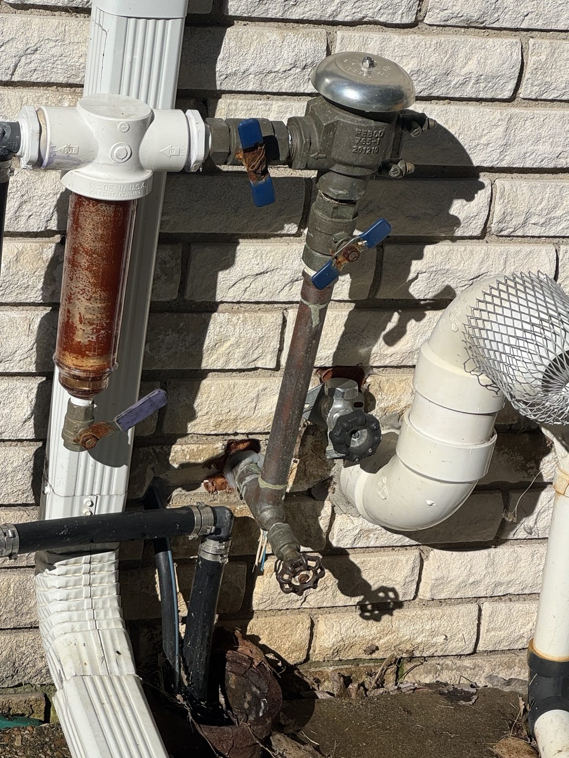 Exterior irrigation plumbing on a 15-zone well-pump system in Shelby Township Michigan